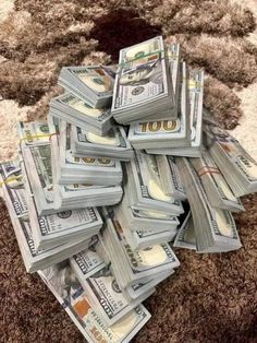 a pile of money sitting on top of a rug