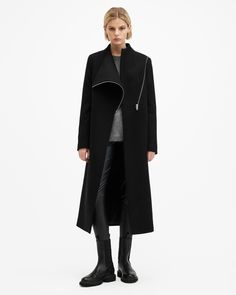 A coat that never fails. This is the Margoh. Made from a recycled wool-blend fabric to a statement asymmetric silhouette that takes its inspiration from our archive designs – they're timeless. Complete with a grown-on neckline and multiple pockets, it's our coat of the season.   This coat is designed to a regular fit that fits true to size Zip closure Long sleeves Midi length Grown on neckline Asymmetric wrap front Two pockets One interior pocket Recycled fabrics The Archive Collection is a cura Chic Allsaints Winter Outerwear, Allsaints Long Sleeve Winter Outerwear, Elegant Allsaints Outerwear For Work, Modern Asymmetrical Zip Outerwear For Work, Modern Structured Outerwear For Fall, Modern Asymmetrical Zip Outerwear For Fall, Modern Outerwear With Asymmetrical Zip For Fall, Modern Fall Outerwear With Asymmetrical Zip, Allsaints Fitted Long Sleeve Outerwear