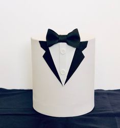 a white cake with a black bow tie on it