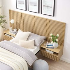 a bed with two vases on each side and a wooden slatted headboard