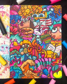 an open notebook covered in colorful doodles and crayons