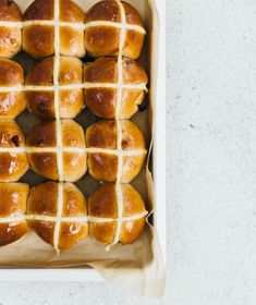 hot cross buns in a baking pan on a table