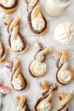 several pastries with icing sitting on wax paper