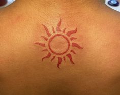 a person with a sun tattoo on their back