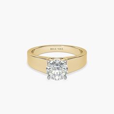 a yellow gold engagement ring with a single diamond