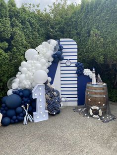 a balloon arch with white and blue balloons