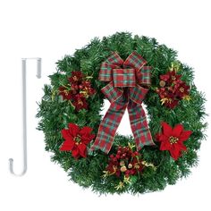 a christmas wreath with red poinsettis and greenery