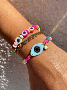 Three different summer bracelets in rainbow colors. A unique bracelet withtiny colorful evil eyes and beads, a gold bangle bracelet with tiny eyes and, and a colrful bracelet with a unique light blue evil eye at the center. You can choose and wear them all together or separetely as well. In Christina Christi Jewels store you can see more than 100 designs in Women's Bracelets. You can have them in 2-4 Days with DHL EXPRESS SHIPPING DIMENSIONS - Every bracelet, has length 16.5 cm (6,3'') - If you Trendy Multicolor Evil Eye Jewelry, Trendy Multicolor Evil Eye Bracelet For Friendship, Multicolor Evil Eye Friendship Bracelets For Festivals, Multicolor Evil Eye Beaded Bracelets For Friendship, Colorful Beads Evil Eye Bracelet For Beach, Beach Evil Eye Bracelet With Colorful Beads, Multicolor Beaded Bracelets With Evil Eye, Multicolor Evil Eye Bracelets For Festival, Festival Evil Eye Bracelet With Colorful Round Beads