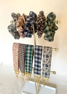 a rack with four different colored bow ties on it