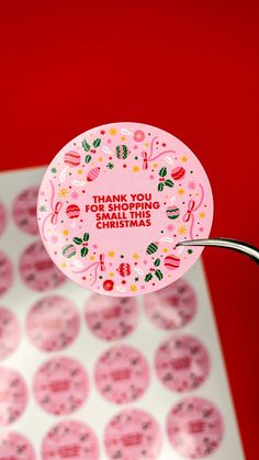 a pink sticker with the words thank you for being small is hanging from a metal hook