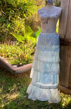 "a silk maxi skirt  in shades of pale blue hand dyed featuring some beautiful vintage pieces of embroidery and fine lace ruffles of patchworked silks and delicate linen gently flared  absolutely one of a kind  SIZE  ~ adaptable ~ when the drawstring waist is ungathered it measures 37\" /  length 41\" / mannequin is size small  cool gentle wash" Lace Tiered Maxi Skirt With Ruffles, Lace Maxi Skirt With Ruffles And Tiered Design, Bohemian Long Skirt In Light Blue, Light Blue Long Bohemian Skirt, Bohemian Tiered Skirt With Lace Trim, Bohemian Ruffled Skirt For Wedding, Wedding Maxi Skirt With Lace Trim, Bohemian Tiered Maxi Skirt For Wedding, Parachute Skirt