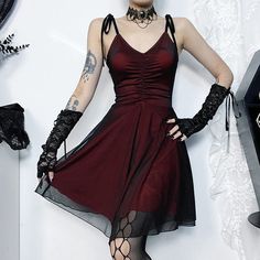 a woman in a red dress and black gloves