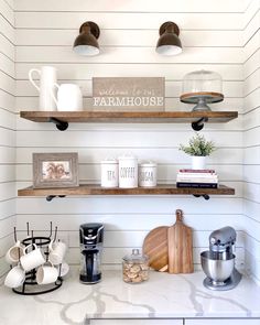 the shelves in this kitchen are filled with coffee cups and other items, including an espresso machine