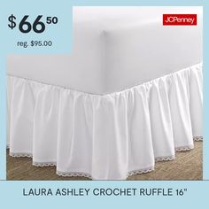 a bed with white ruffled bedskirt and price tag for $ 66 50