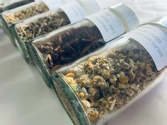 three bottles filled with different types of herbs