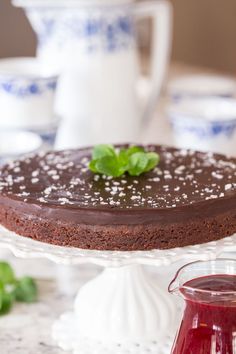 a chocolate cake sitting on top of a white plate