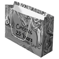 a black and white marbled paper bag with the words cheese 25 years on it