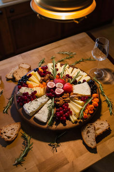 Cheese board with assorted cheeses, fresh fruits, and nuts on a wooden table, lit by a warm lamp. Cheese Boards Display, Gourmet Cheese Board, Fruits Board Ideas, Best Cheese Board Ideas, Cheese Board Christmas, New Years Food Board Ideas, Toast Charcuterie Board, Cheese Board Vegetarian, Nut Charcuterie Board