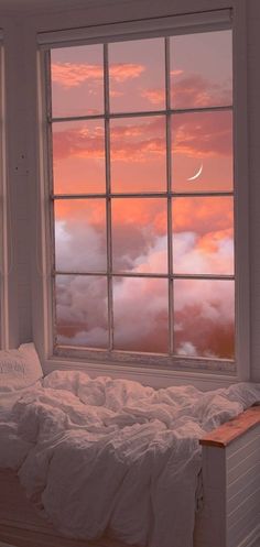 a bed sitting under a window next to a night stand with a moon in the sky