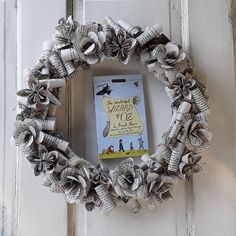 a book page wreath is hanging on the door