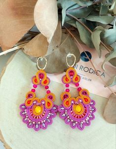 Large fuchsia flowers beaded earrings, hot pink soutache dangle earrings, perfect summer earrings,  birthday gift for her, present for wife. Orchid flower inspiration for this pair of handmade embroidery earrings.  Made in soutache embroidery technique with: ☆Soutache cord colors : czech viscoza orange, pink fuchsia, purple  color  ☆Crystals, beads colors  : 4-10 mm orange and pink crystals, ☆Seed beads toho colors : pink 11/0 , orange 8/0 ☆Earrings hooks : silver plated  ☆Back side: brown leath Soutache Embroidery, Embroidery Earrings, Beads Colors, Presents For Wife, Fuchsia Flowers, Fuchsia Purple, Crystals Beads, Flower Inspiration, Summer Earrings