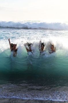 three people are swimming in the ocean together