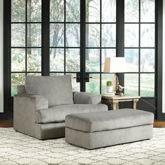 a living room scene with focus on the chair and ottoman