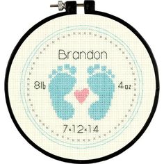 a cross stitch baby's feet with the name brandon on it and a heart