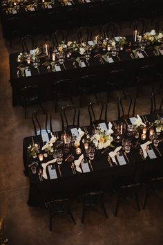 an overhead view of a long table with black chairs and white napkins on it