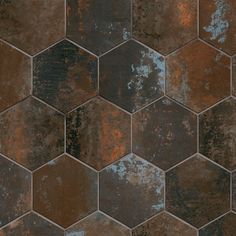 a brown and black hexagonal tile pattern with rusted paint on the edges