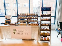 the table is set up in front of large windows with shelves full of jams