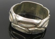 "EESCORCIA MEXICO 925 Silver - Vintage Sculpted Hollow Bangle Bracelet - BT4319  EESCORCIA MEXICO 925 Silver - Vintage Sculpted Hollow Bangle Bracelet - BT4319  Jewelry Type:         Bracelet   Metal Type:            925 Silver  Metal Size:             6.25\" Length  1\" Height   Stone Type:            N/A  Condition:              N/A  Jewelry Weight:     80.1 Grams  PLEASE NOTE: THIS ITEM IS PRE-OWNED. ALTHOUGH MOST ITEMS ARE IN VERY GOOD CONDITION, SOME MAY NEED CLEANING AND/OR MINOR REPAIRS. Luxury Silver Band Jewelry, Modern Silver Band Bracelet, Modern Formal Bracelets Stamped 925, Silver Polished Band Jewelry, Bracelet Metal, Jewelry Inspo, Metal Bracelets, Bangle Bracelet, Handmade Silver