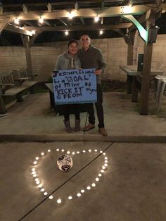 two people standing in front of a sign that says goal is this way to be from