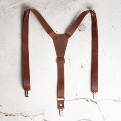 Suspenders are a stylish and unusual alternative to a traditional belt. They are made of durable and high-quality genuine leather, which will make your look more presentable. Leather suspenders will become a highlight of your wardrobe. It will make you stand out from the crowd and help you create a gallant look. Genuine leather suspenders are an ideal accessory for business meetings, various events and celebrations. You can wear them to your own wedding or the wedding of your friends. This is a Classic Adjustable Belt With Leather Strap, Adjustable Brown Belts And Suspenders For Business, Adjustable Leather Belts And Suspenders For Business, Luxury Leather Belts And Suspenders, Formal Leather Belts And Suspenders, Vintage Leather Belts And Suspenders For Business, Elegant Leather Suspenders, Leather Strap Belts And Suspenders For Business, Luxury Men's Leather Strap Belts And Suspenders