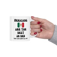 a woman's hand holding a coffee mug with mexicans are the best in bed