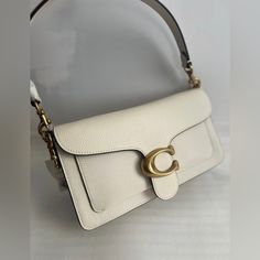 The Price Is Firm! Please Do Not Send Any Offer! Thanks! Polished Pebble Leather Inside Zip And Multifunction Pockets Snap Closure, Fabric Lining Outside Slip Pocket Detachable Short Strap With 7 3/4" Drop Detachable Long Strap With 21 1/4" Drop For Shoulder Or Crossbody Wear 10 1/4" (L) X 6" (H) X 3" (W) Style No. 73995 Classic White Flap Bag With Branded Hardware, White Clutch Flap Bag With Dust Bag, Coach Flap Bag With Detachable Strap For Daily Use, Classic Cream Bags With Branded Hardware, Elegant Flap Bag For Daily Use With Branded Hardware, Cream Shoulder Bag With Branded Hardware For Formal Occasions, Elegant Daily Use Flap Bag With Branded Hardware, Formal Cream Shoulder Bag With Branded Hardware, Everyday Flap Shoulder Bag With Branded Hardware