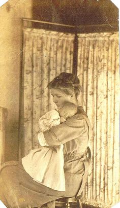 an old photo of a woman sitting on a chair