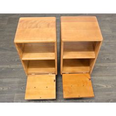 two wooden bookshelves sitting on top of a hard wood floor next to each other