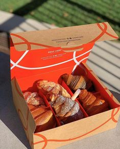 an open box of baked goods sitting on a table