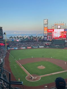 a baseball field with lots of people on it and many fans in the bleachers