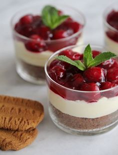 a dessert with raspberries and whipped cream on the top is garnished with mint leaves