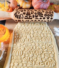 an intricately designed cookie sheet with pumpkins in the background