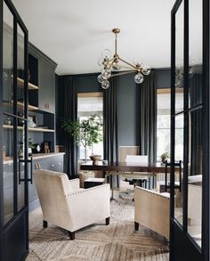 a living room filled with furniture and a chandelier hanging from the ceiling next to a window