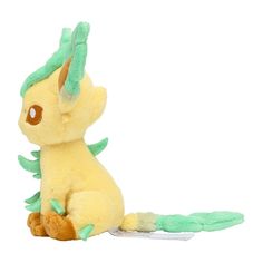 a yellow stuffed animal with green leaves on it's head and tail, sitting in front of a white background