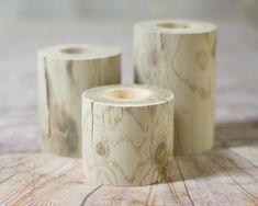 three pieces of wood sitting on top of a wooden table