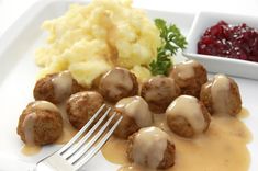 a plate with meatballs, mashed potatoes and cranberry sauce