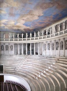 the interior of a large building with statues on it's walls and an artistic ceiling