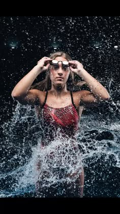 a woman standing in the water with her hands on her head