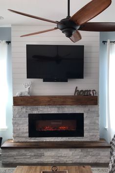 a living room with a fireplace and flat screen tv mounted on it's wall