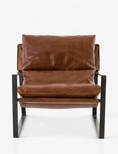 a brown leather chair sitting on top of a metal frame